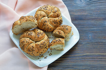 Kaiser rolls (Emperor roll, kajzerica),  round bread rolls on rustic table. Copy space