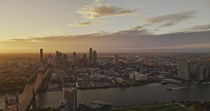 NYC New York Aerial v368 flyover East river capturing Roosevelt Island, Queensboro Bridge, Queens cityscape with golden glowing sun rising on the horizon - Shot with Mavic 3 Pro Cine - September 2023