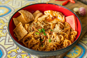 a bowl of spicy noodles close up
