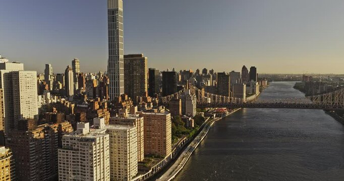 NYC New York Aerial v390 drone flyover East river along FDR drive capturing riverside traffic, Midtown Manhattan and Upper East Side cityscape at sunrise - Shot with Mavic 3 Pro Cine - September 2023