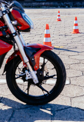 Concept of motorcycle school of driving. Riding between cones, lesson in motorcycle school