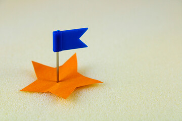 Thumbtack with flag selecting a star