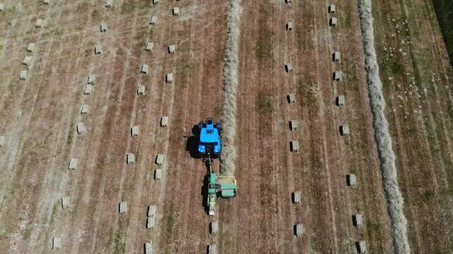 Baler presses hay into square bales.