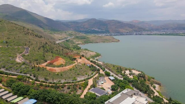 Panning drone footage of the Luo Quan Peninsula Tourism Zone and the majestic view of Er Hai