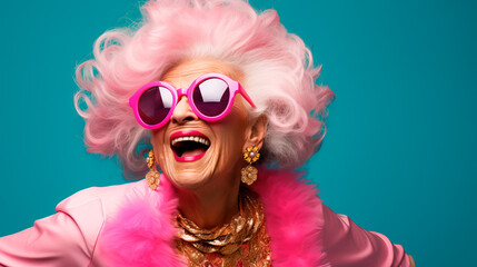 Cheerful glamorous old woman with gray hair dressed in pink. Concept of fun old age or eternal youth