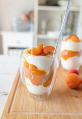 Summer Dessert with fresh apricot compote, skyr and roasted almonds in glasses