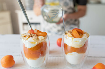 Homemade food with a healthy fruit dessert with quark and apricot compote and almond topping