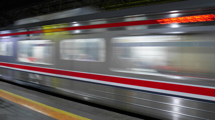 Motion blur of a silver train carriage.