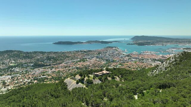 Toulon city and Mediterranean sea. Fort Faron in foreground, France. Aerial backwards