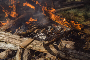 Food cooked on a bonfire on the grill over an open fire.
