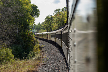 Fototapeta premium Passenger train cars going around curve