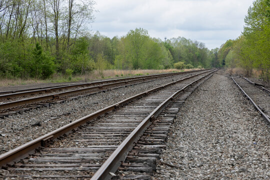 Multiple rows of bolted railroad tracks in landscape
