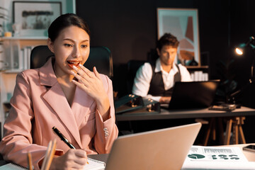 Focusing on happy face woman with pink suit getting marketing online project on email sending back...