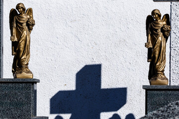 Shadow of a cross between two angels in the cemetery of Alhambra