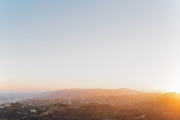 Horizontal image of the sun setting over Los Angeles California hills