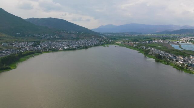 As the drone soars over the lake, viewers can see the surrounding landscape, creating a mirror-like effect.