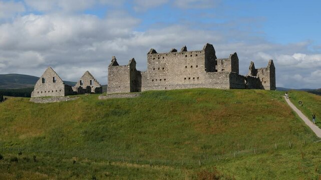 Ruins of Ruthven Barracks in Cairngorms National Park near Kingussie city, Scotland at sunny day, unrecognizable tourists, static shot
