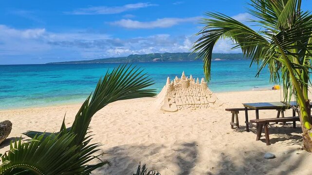 Puka Beach on Boracay Island, Philippines, Sand Castle and Table on White Sand Behind Green Tropical Trees