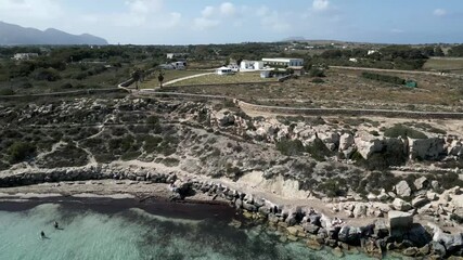 Drone fly above Favignana island coastline Aegadian Islands  aerial high angle view of Mediterranean Sea beach