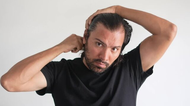 man using brush on his head with baldness, Hair strands