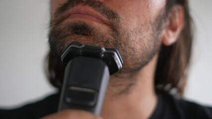 Latino man trimming beard and mustache with electric razor, Shave,