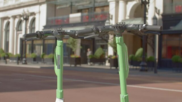Top view of two electric scooters in downtown Grand Rapids, Michigan with stable video close up.