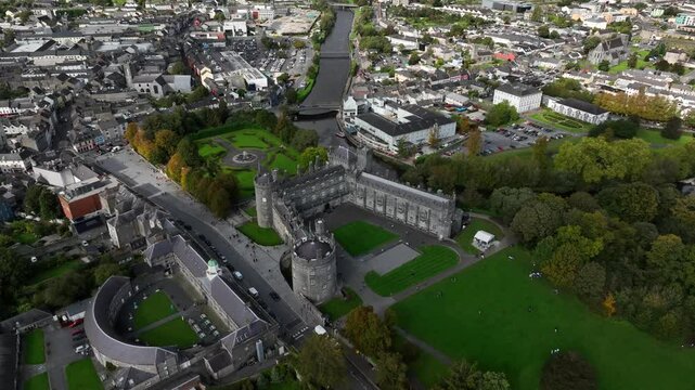 Kilkenny Castle, County Kilkenny, Ireland, September 2023. Drone orbits away from the historic building as shadows glide across the city with Saint Canice and Mary's Cathedrals in the background.