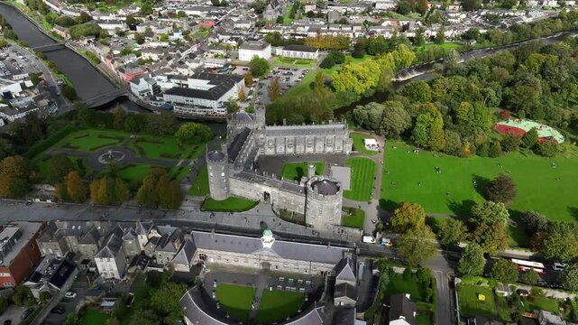Kilkenny Castle, County Kilkenny, Ireland, September 2023. Drone orbits revealing the elegant formal gardens as shadows roll across architecture and green landscape.