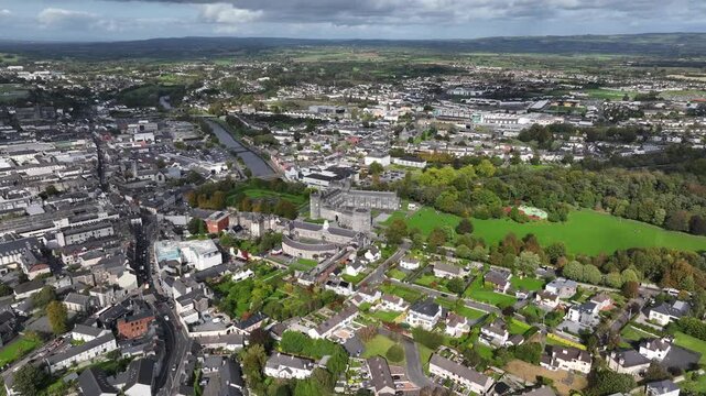 Kilkenny Castle, County Kilkenny, Ireland, September 2023. Drone at a higher angle orbits the estate while gradually descending with views north towards The Church of Saint John the Evangelist.