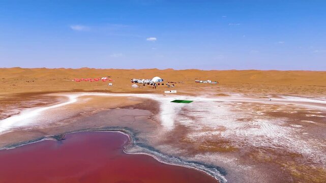 Flyover aerial view of the famous pink and heart-shaped Wulan Lake in the Tengger Desert, Inner Mongolia Autonomous Region, China.