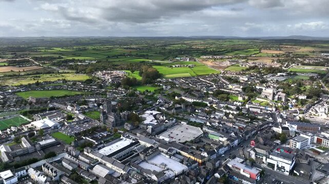 Kilkenny Town, County Kilkenny, Ireland, September 2023. Drone at a higher angle pulls backwards across the town with Saint Mary's Cathedral, The Black Abbey and Saint Canice's Cathedral in view.