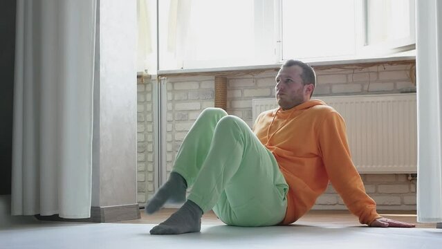 A dancer is warming up, a male gymnast is in training. Handsome sportsman at dance lessons