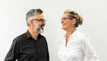 A Man and Woman in Their 40s Laughing Together Against a White Background