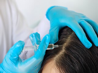 Hair Loss Treatment With A Syringe Injection In A Medical Setting
