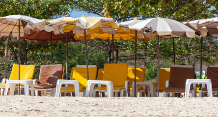 Sun loungers with umbrellas on the sandy beach