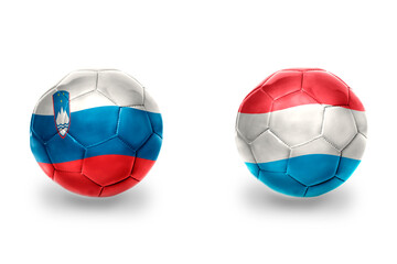 Fototapeta premium football balls with national flags of luxembourg and slovenia ,soccer teams. on the white background.
