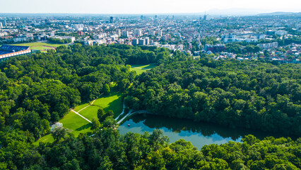 A stunning aerial view of Park Maksimir in Zagreb, showcasing its vast greenery, beautiful lakes,...
