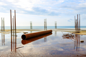 a rusty pipe at a construction site on the seashore