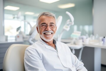Fototapeta premium Portrait of a smiling senior male patient at dentist office