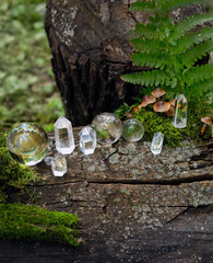 crystal minerals in forest, natural background. clear quartz gemstones for Magic Crystal Ritual,...