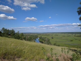 Obraz premium Scenery. Hills, mountains, river, nature. Trees, horizon, sky 