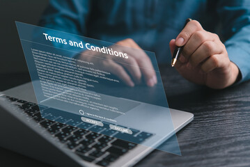 Hand signing digital terms and conditions document on laptop screen. Legal agreement, contract approval. Business technology concept. Online policy consent.