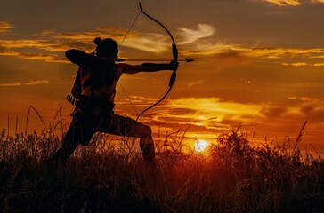 Silhouette of an Archer Aiming at Sunset in a Field of Grass