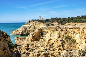 Portuguese coast in Benagil, Algarve, Portugal. Alfanzina Lighthouse. Seven Hangging Valleys Trail.