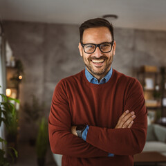 Obraz premium Portrait of adult handsome man with eyeglasses stand and smile at home