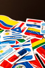 High angle view of different latin america country flag stickers with copy space on table
