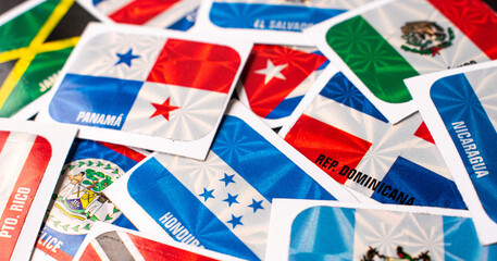 High angle view of different central america country flag stickers on table
