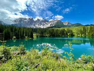 Panoramic view of Carezza lake in the Italian Dolomites on sunny day of spring in Italy