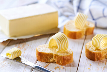 French bread Baguette and butter curls on a kitchen table,selective focus.