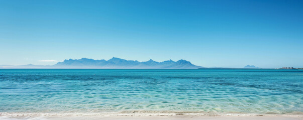 Beach background with distant mountains and a clear blue horizon.